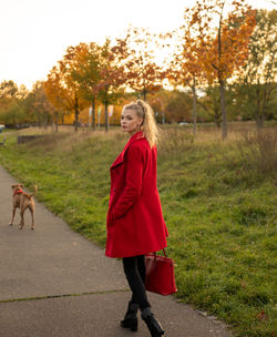 Full length of woman with red umbrella