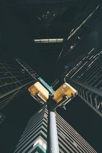 Low angle view of illuminated lighting equipment at night