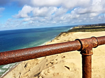 Close-up of rusty railing against sea