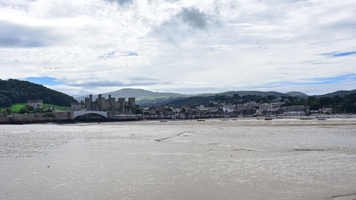 Scenic view of sea and buildings against sky