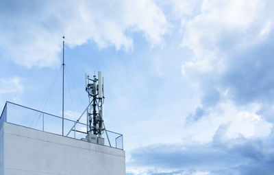 Low angle view of communications tower against sky