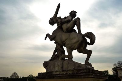 Low angle view of statue against sky in city