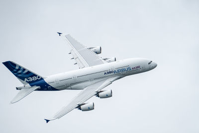 Low angle view of airplane flying against clear sky