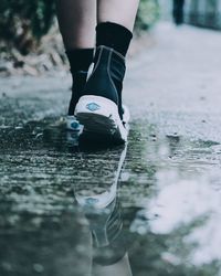 Low section of man standing in water