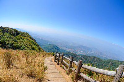 Scenic view of landscape against blue sky