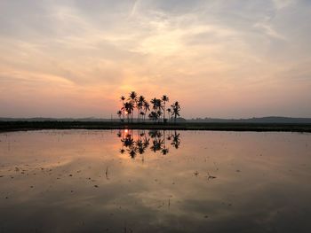 Scenic view of lake against sky during sunset