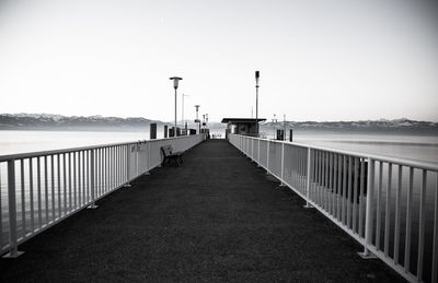 View of pier on sea against clear sky