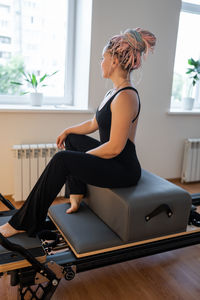 Young woman exercising in gym