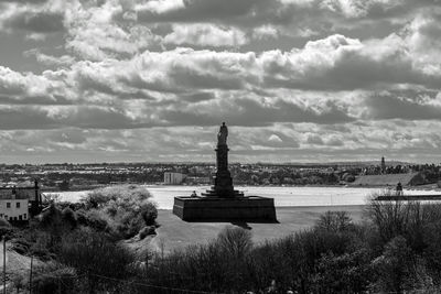 Statue of liberty against cloudy sky