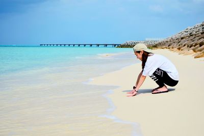 Woman on beach against sky