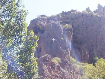 Low angle view of tree mountain against sky