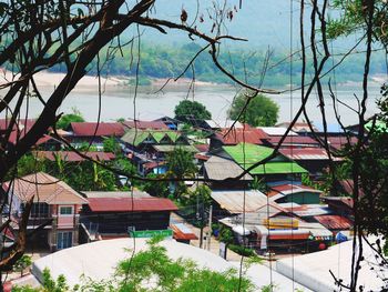 High angle view of buildings and trees against sky