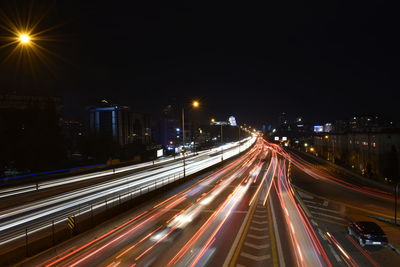 High angle view of light trails on road at night