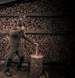 Full length of man working on log