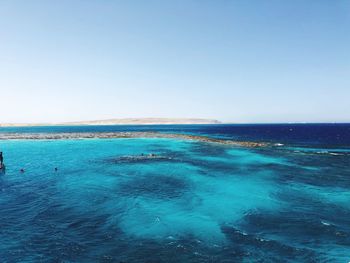 Scenic view of sea against clear blue sky