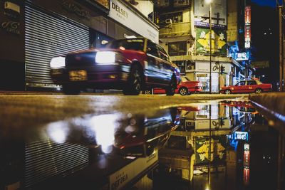 Cars on illuminated city at night