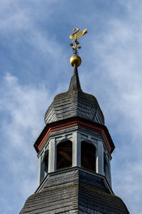 View on the church spire with golden swan in monschau, eifel, germany