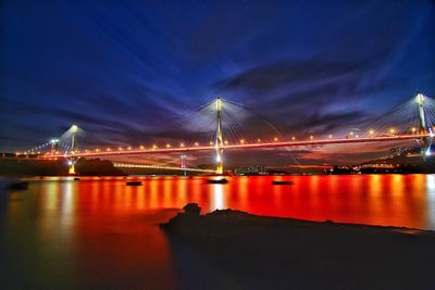 Low angle view of suspension bridge at night