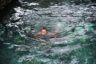 High angle view of woman swimming in lake