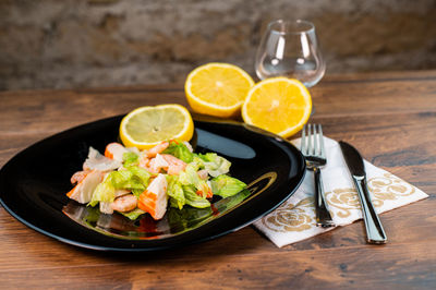 High angle view of fruits in plate on table