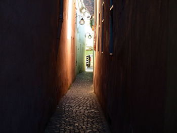 Empty alley amidst buildings in city