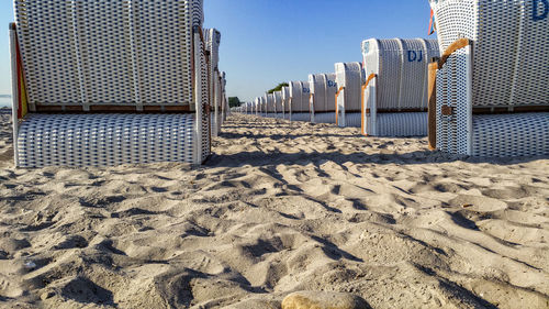 Hooded beach chairs on sandy beach