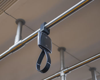 Low angle view of chain hanging on railing