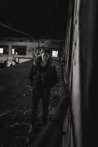 Portrait of young woman standing in abandoned building