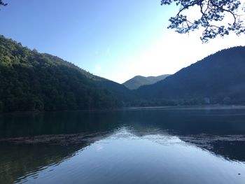 Scenic view of lake and mountains against sky