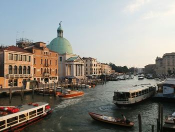 Boats in river with buildings in background