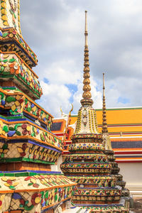 Low angle view of temple building against cloudy sky