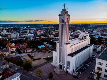 High angle view of illuminated buildings in town against sky