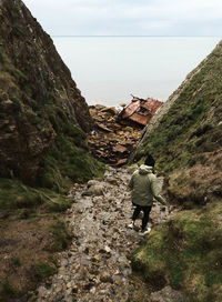 Rear view of man walking on mountain