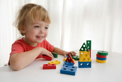 Little boy playing with colorful block