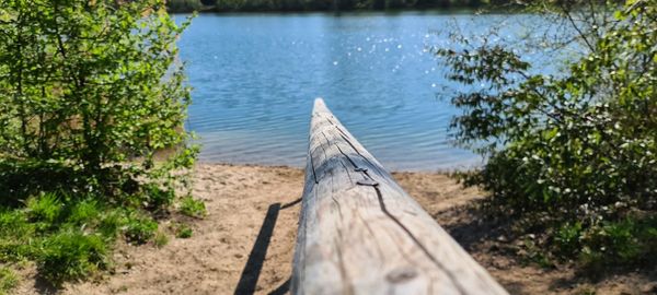 Wooden footpath by lake