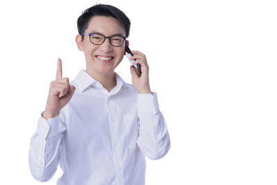 Portrait of smiling man standing against white background