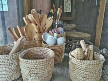 Cooking utensils in wicker containers on table for sale