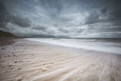 Scenic view of sea against cloudy sky