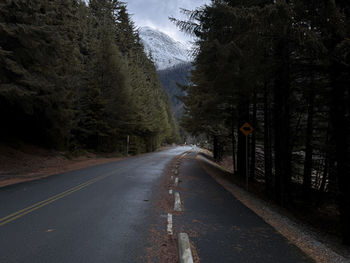 Road amidst trees in forest