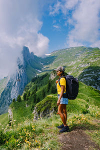 Full length of man standing on mountain against sky