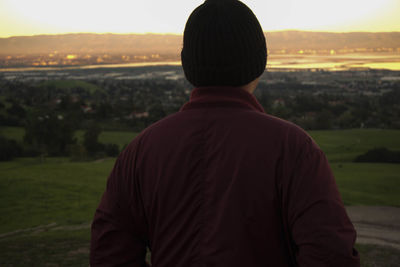 Rear view of man standing on field