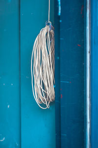 Cables hanging from blue wall