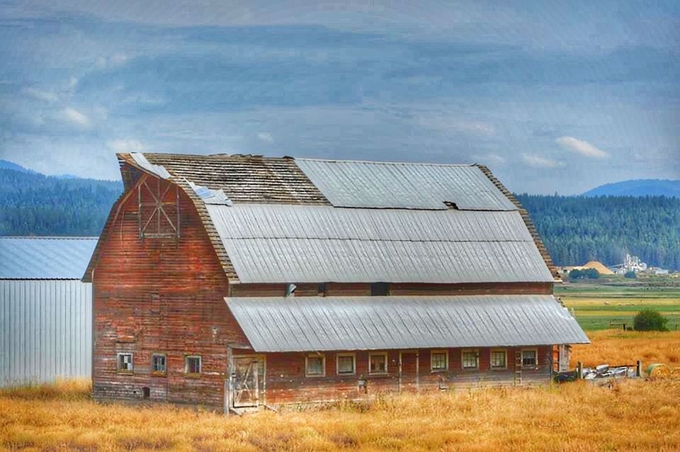 building exterior, architecture, built structure, house, sky, residential structure, roof, rural scene, cloud - sky, field, residential building, grass, landscape, barn, mountain, day, cloud, exterior, outdoors, village