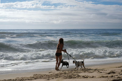 Woman with dogs on beach