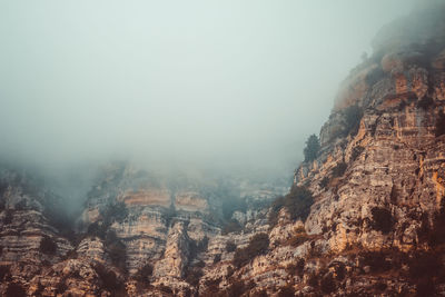 Scenic view of mountains against sky during foggy weather