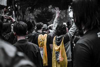 Rear view of people standing in street