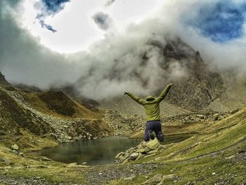 Man jumping against mountains