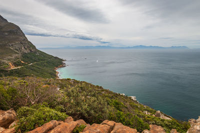 Scenic view of sea and mountains against sky