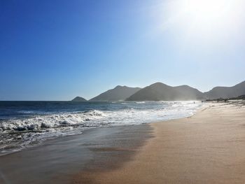 Scenic view of beach against clear sky