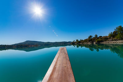 Scenic view of lake against blue sky